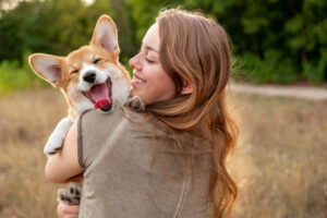Girl smiling while carrying a dog