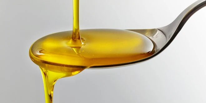 Syrup being poured on a spoon